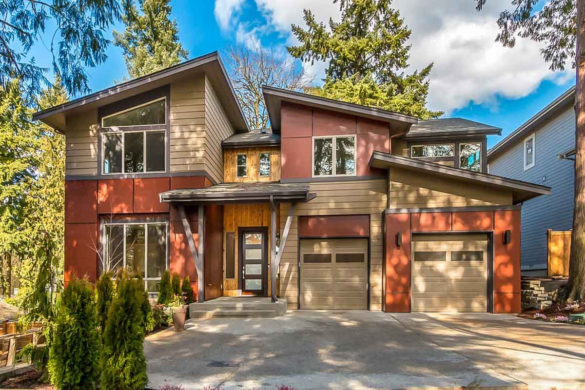 House plan exterior. Two-story modern style home with shed roof, two-car garage, and large windows. Features include a covered entry and wood accents.