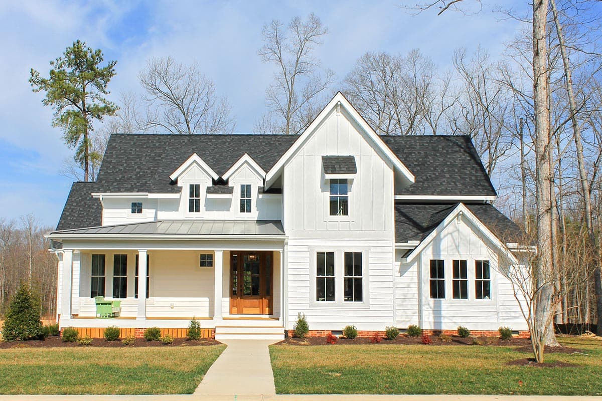 Modern Farmhouse house plan exterior with wrap-around porch, prominent gables, and board-and-batten siding.