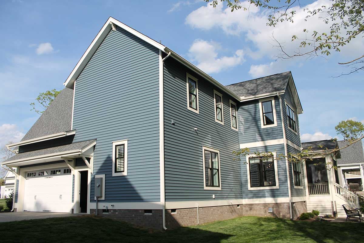 Modern Farmhouse house plan exterior with blue siding, two stories, gabled roof, and attached garage.