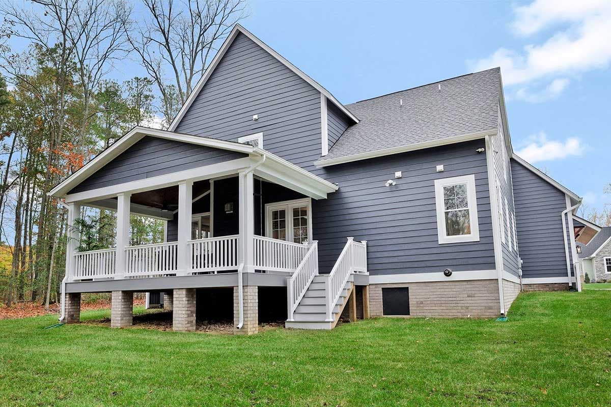 House plan exterior: Two-story Modern Farmhouse with covered porch, gables, and brick foundation.