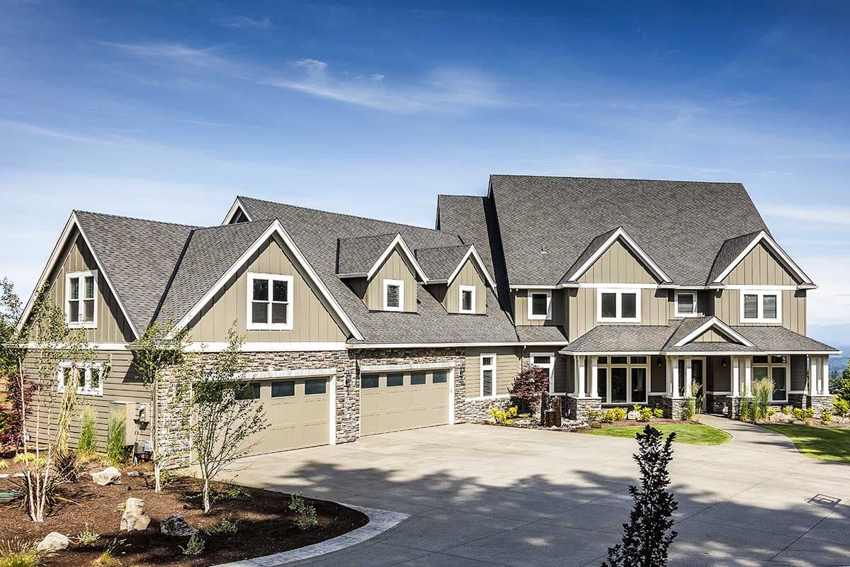 House plan exterior with stone accents, multiple gables, and a mix of gable and hip rooflines. Two-story with attached garage.