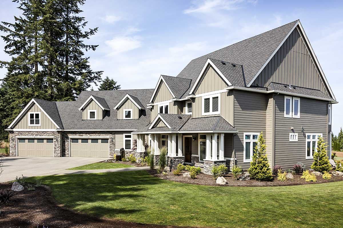 House plan exterior: two-story modern house with a three-car garage, stone accents, covered porch, and dormers.