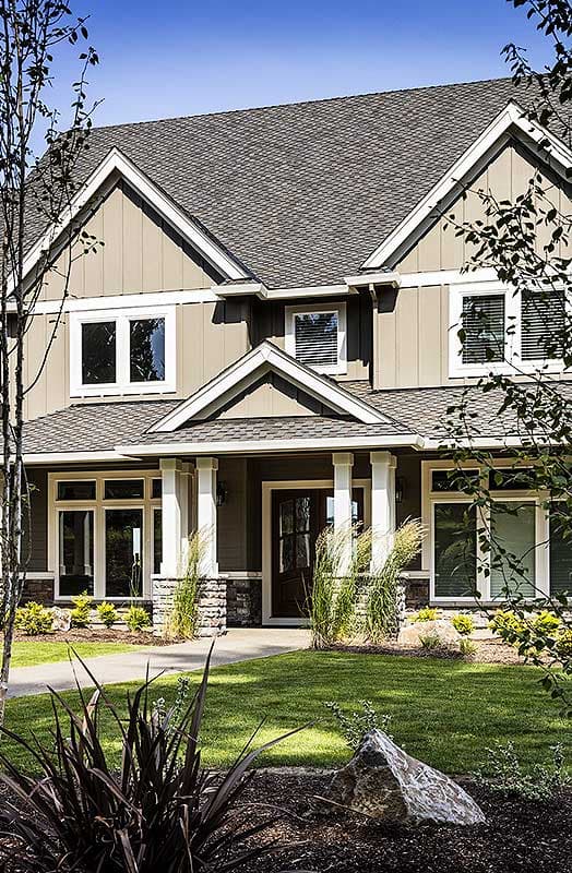 House plan exterior, two-story Modern Farmhouse with gabled dormers, stacked stone accents, and a covered front porch with white columns.