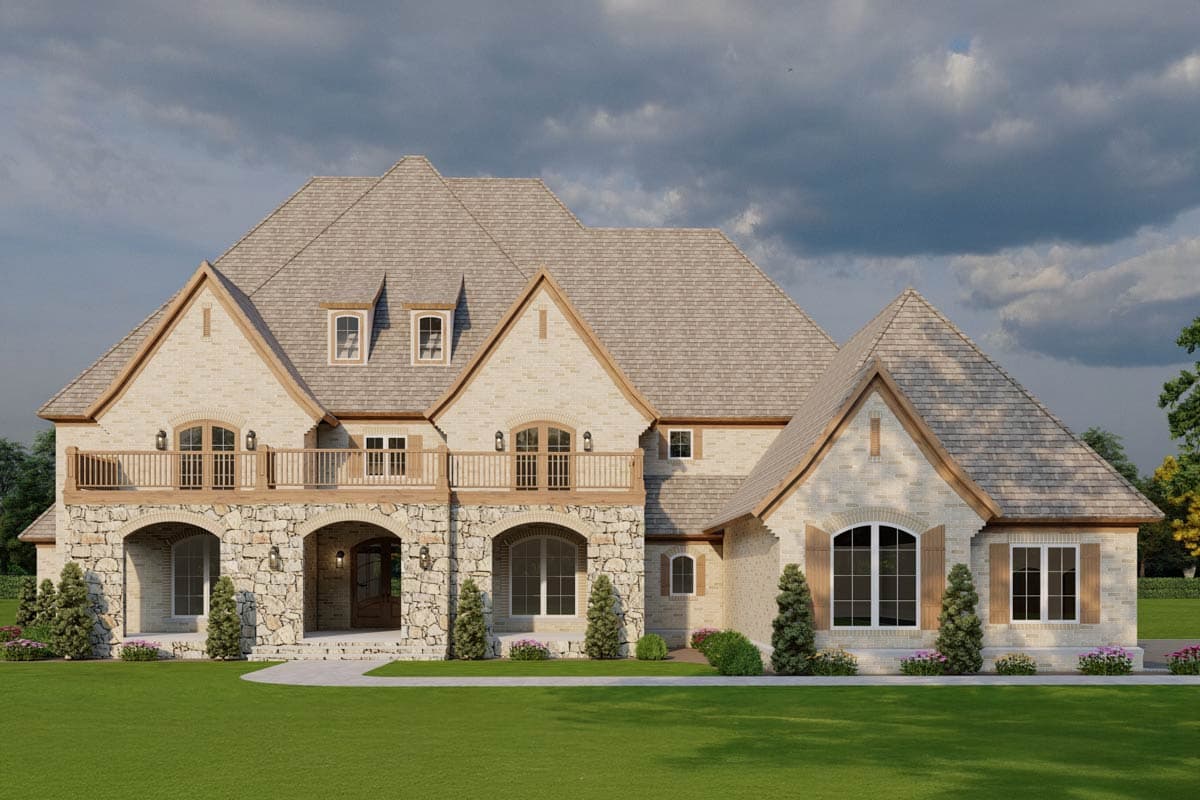House plan exterior with stone accents, arched entryway, second-story balcony, and multiple gables.