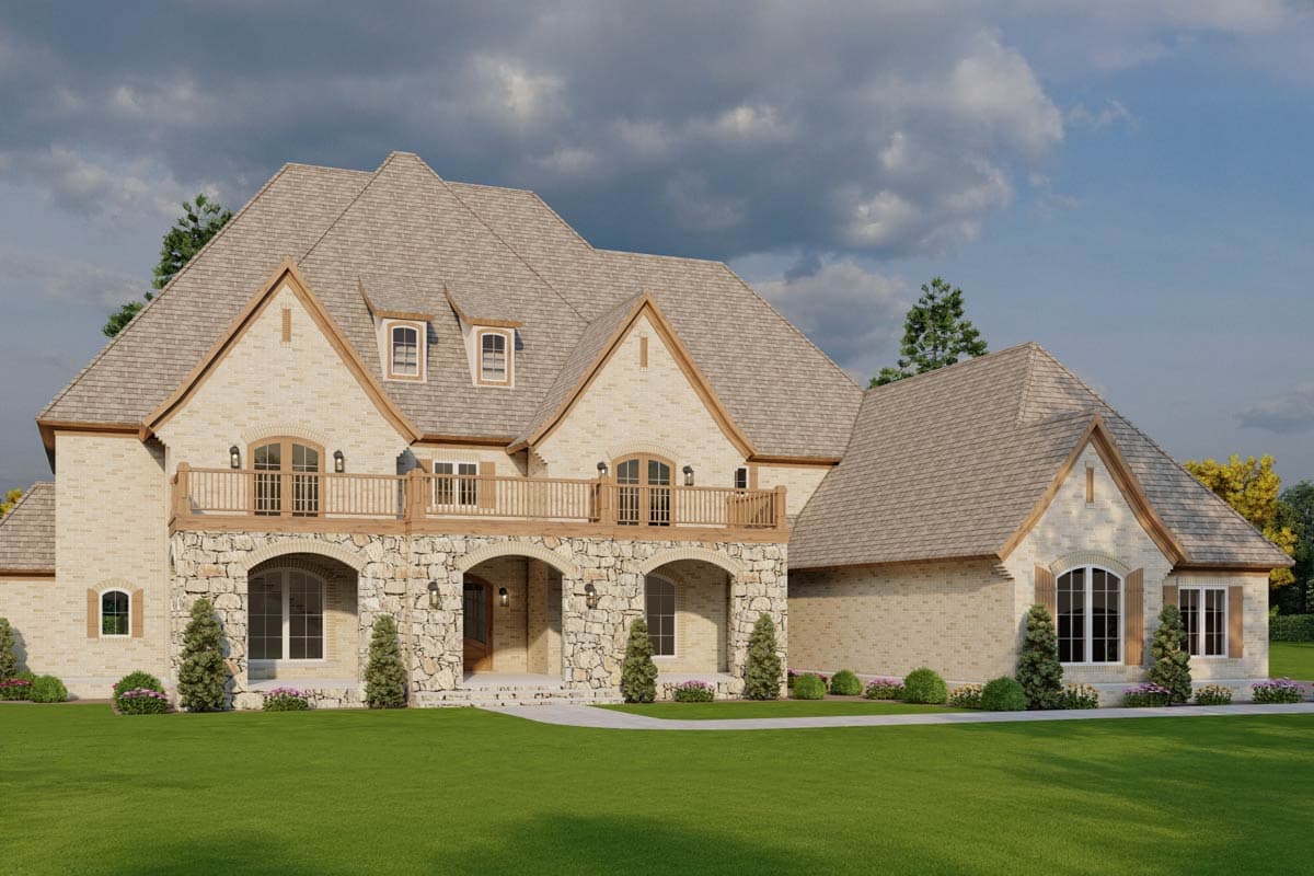 House plan exterior: Two-story French Provincial style with arched stone entryway, second-level balcony, and multiple gables.