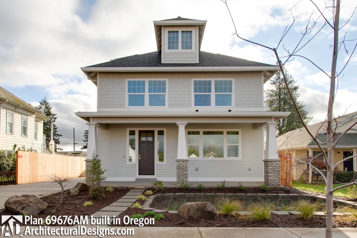 House plan exterior: Two-story Modern Farmhouse with dormer, covered porch supported by columns, and prominent gable.