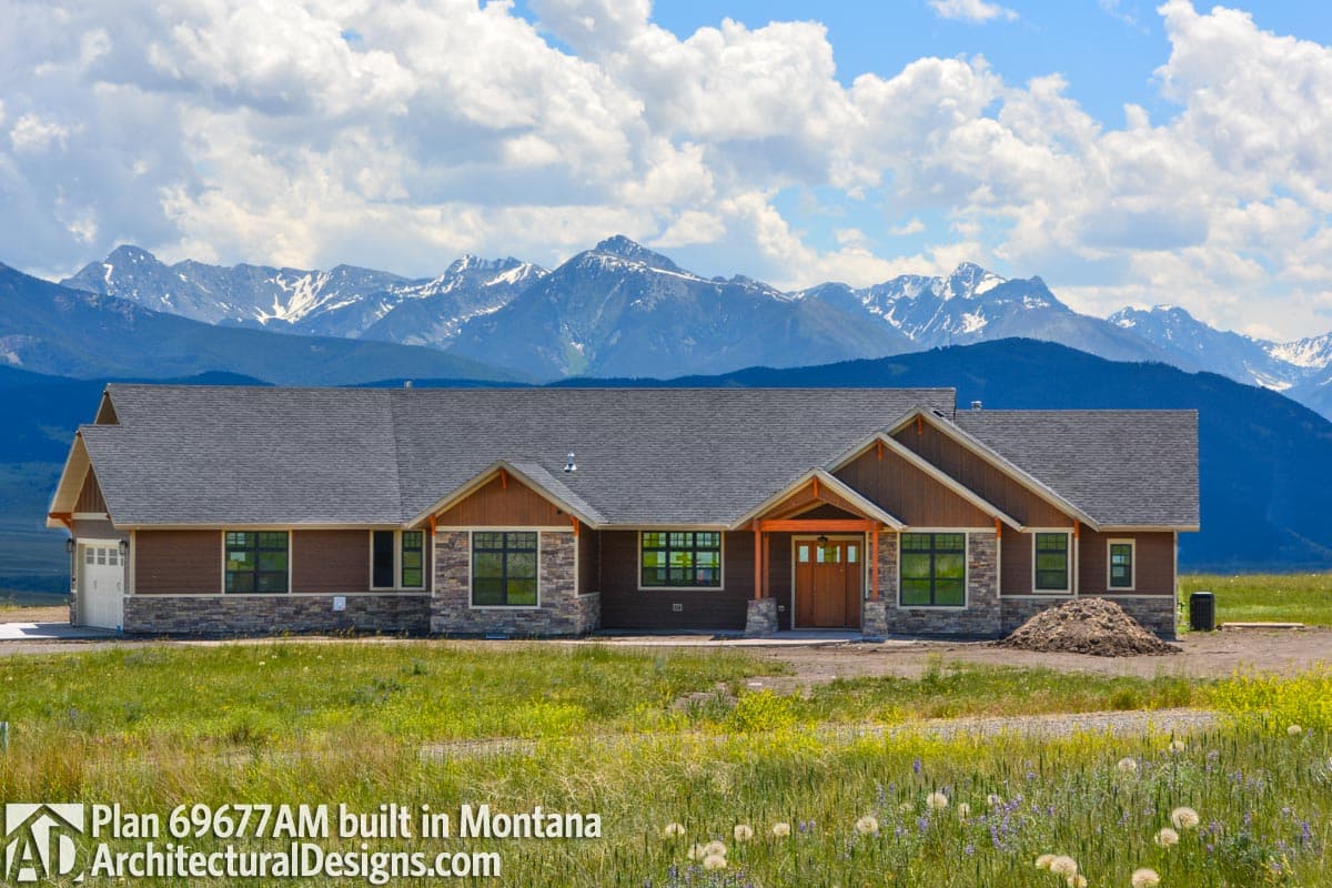 Modern Ranch house plan exterior with stone accents, wood trim, prominent gables, and a covered entry.