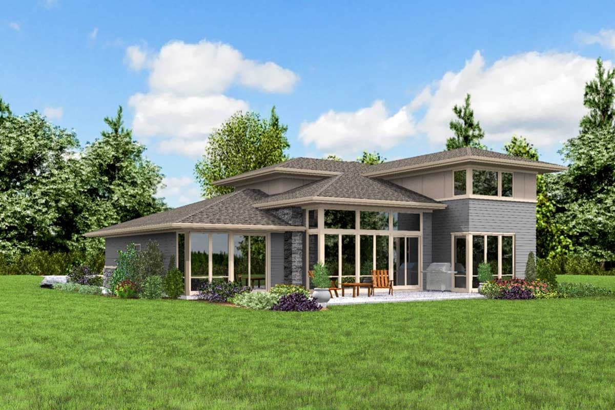 House plan exterior: Modern style, two stories, multiple rooflines, stone accents, and extensive glass.