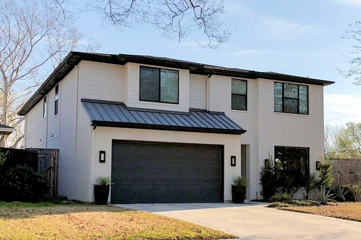 House plan exterior. Two-story modern style home with a garage, shed roof over entry, and dark metal roof accents.