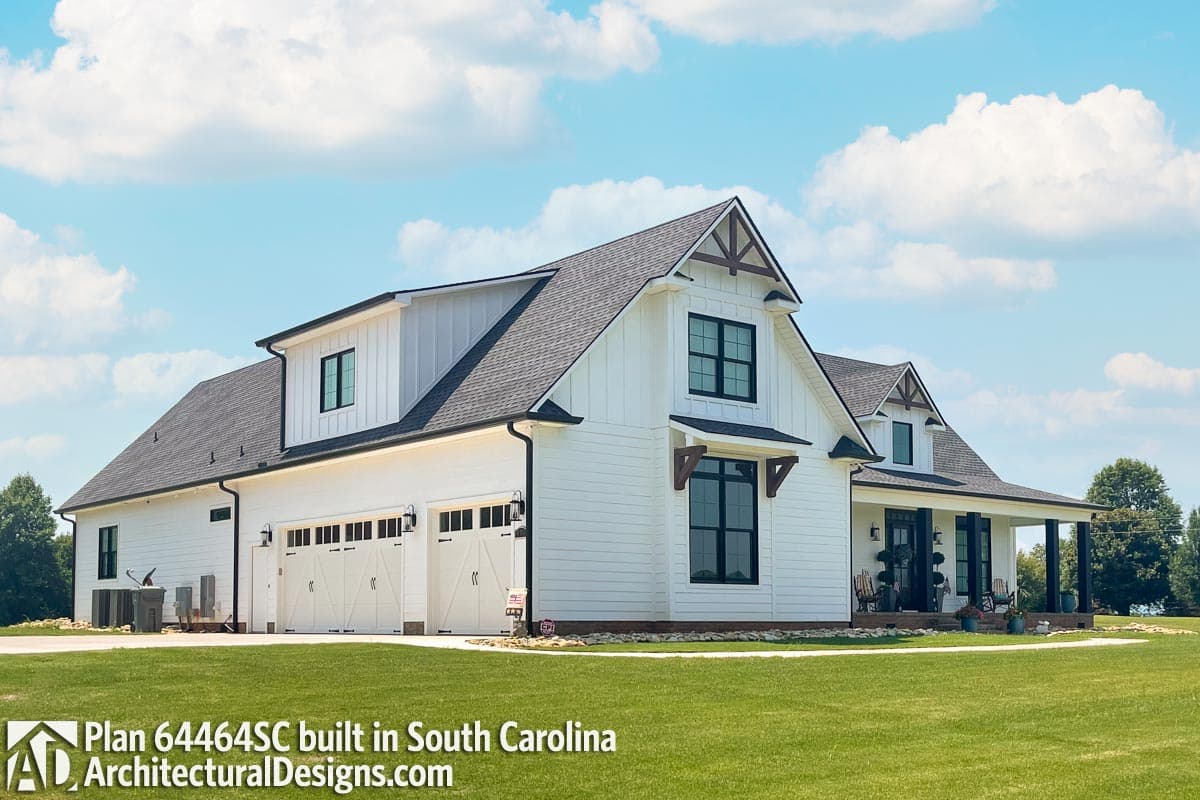 Modern Farmhouse house plan exterior with three-car garage, gables with exposed rafters, and wrap-around porch.