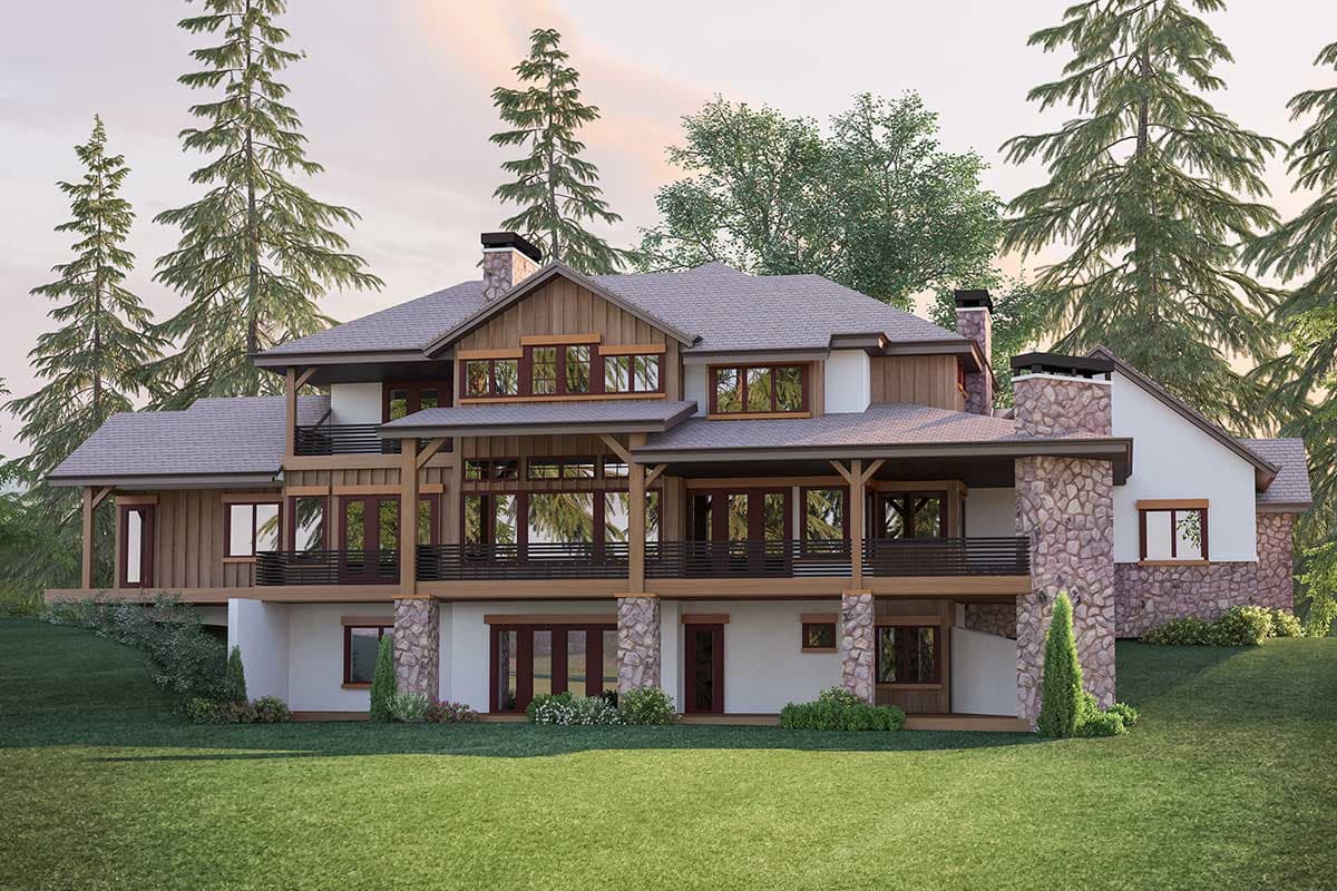 House plan exterior: Timber frame home with multiple gables, stone chimney, and expansive decks.
