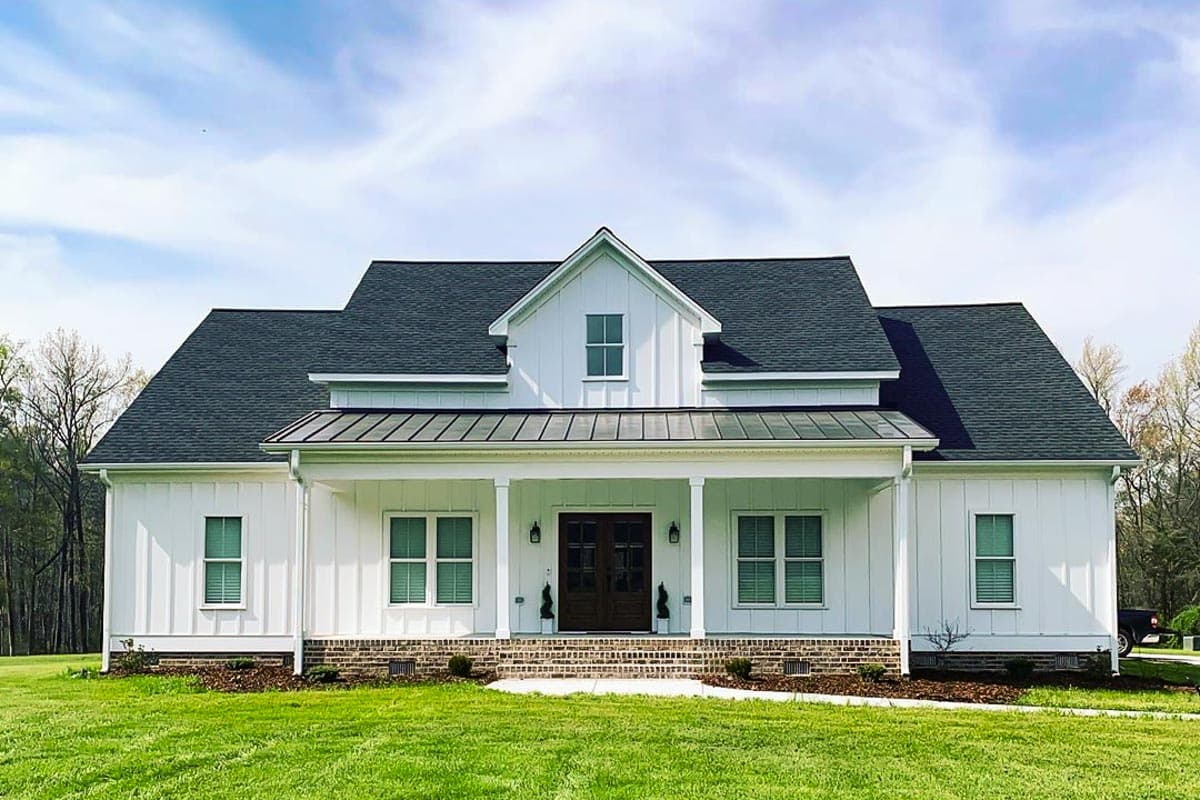 House plan exterior. Modern Farmhouse style, one-story home with a gabled roof, covered porch, and dormer.