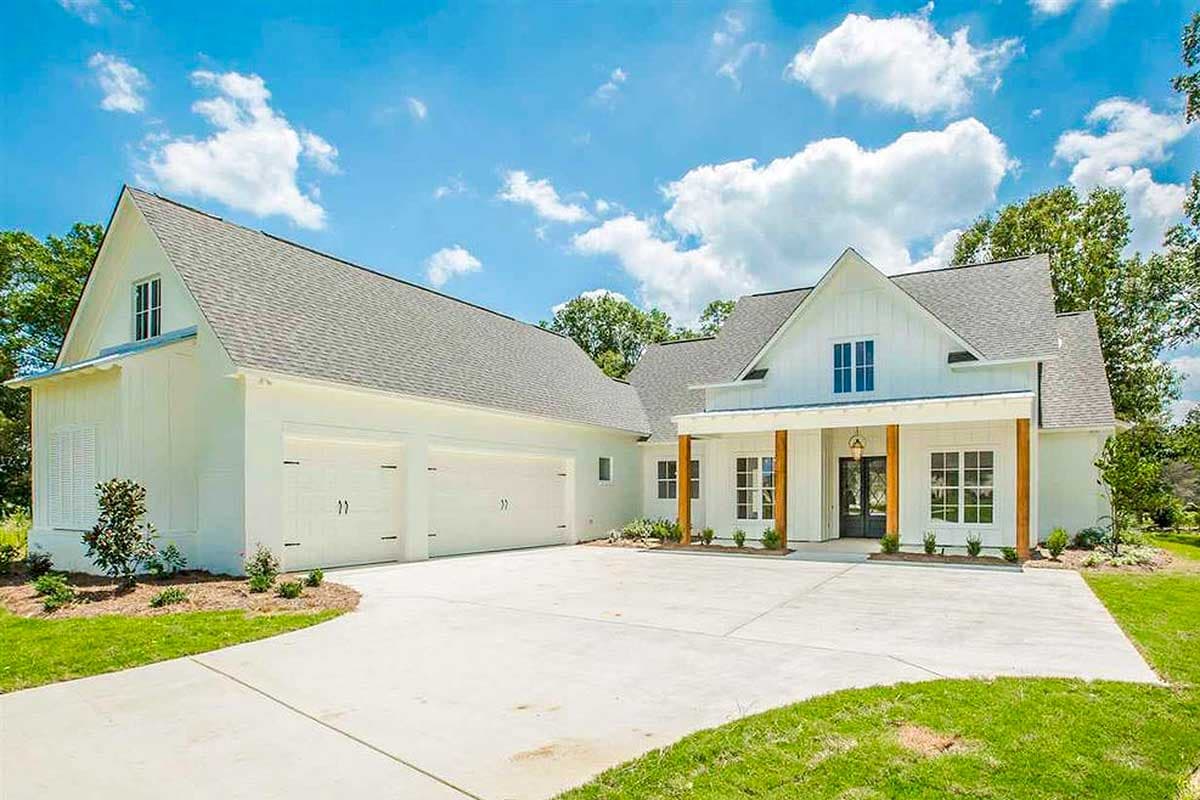 Modern Farmhouse house plan exterior with a side-entry three-car garage, prominent gables, and a covered front porch with wooden posts.