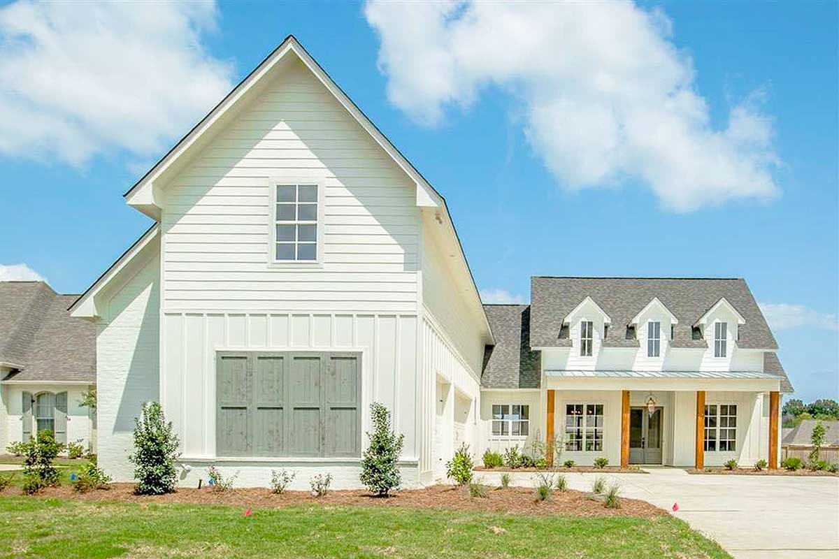 Modern Farmhouse house plan exterior with board and batten siding, dormers, and a covered porch with wood columns.