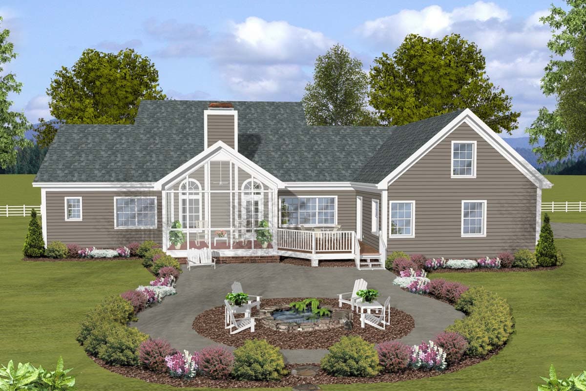 House plan exterior featuring a sunroom with arched windows, a deck, and multiple gables.