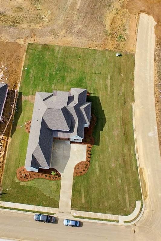 House plan exterior: Two-story home with multiple gables, a prominent roofline, and a side-entry garage.