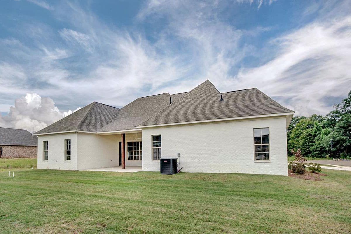 House plan exterior, single-story white brick home with gable rooflines, covered patio, and multiple windows.