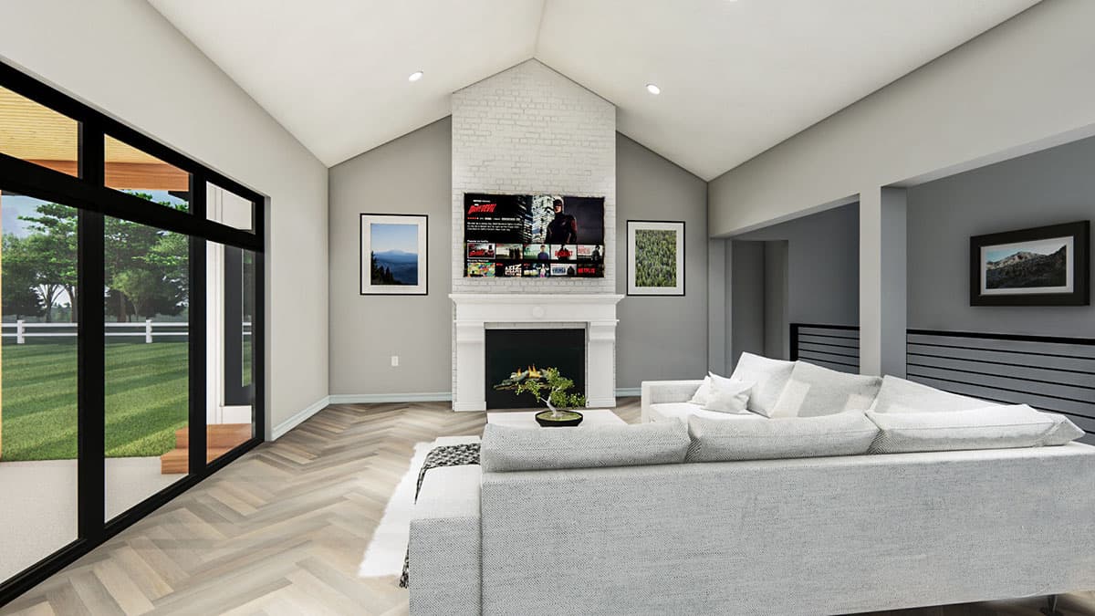 Living room with vaulted ceiling, fireplace, large windows, and open layout.