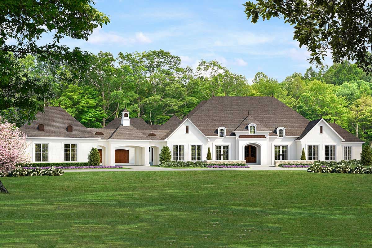 House plan exterior: White two-story home with arched entry, dormers, gables, and attached three-car garage.