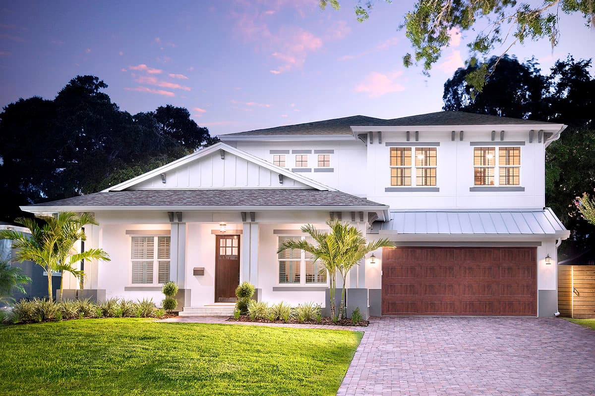 House plan exterior. Two-story Modern Farmhouse with a front porch, gables, and a prominent garage. Features include a brick paver driveway.