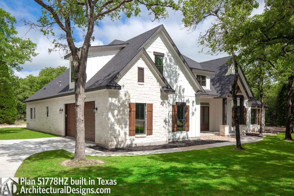 Modern Farmhouse house plan exterior with stone and board-and-batten siding, gables, and a two-car front-entry garage.
