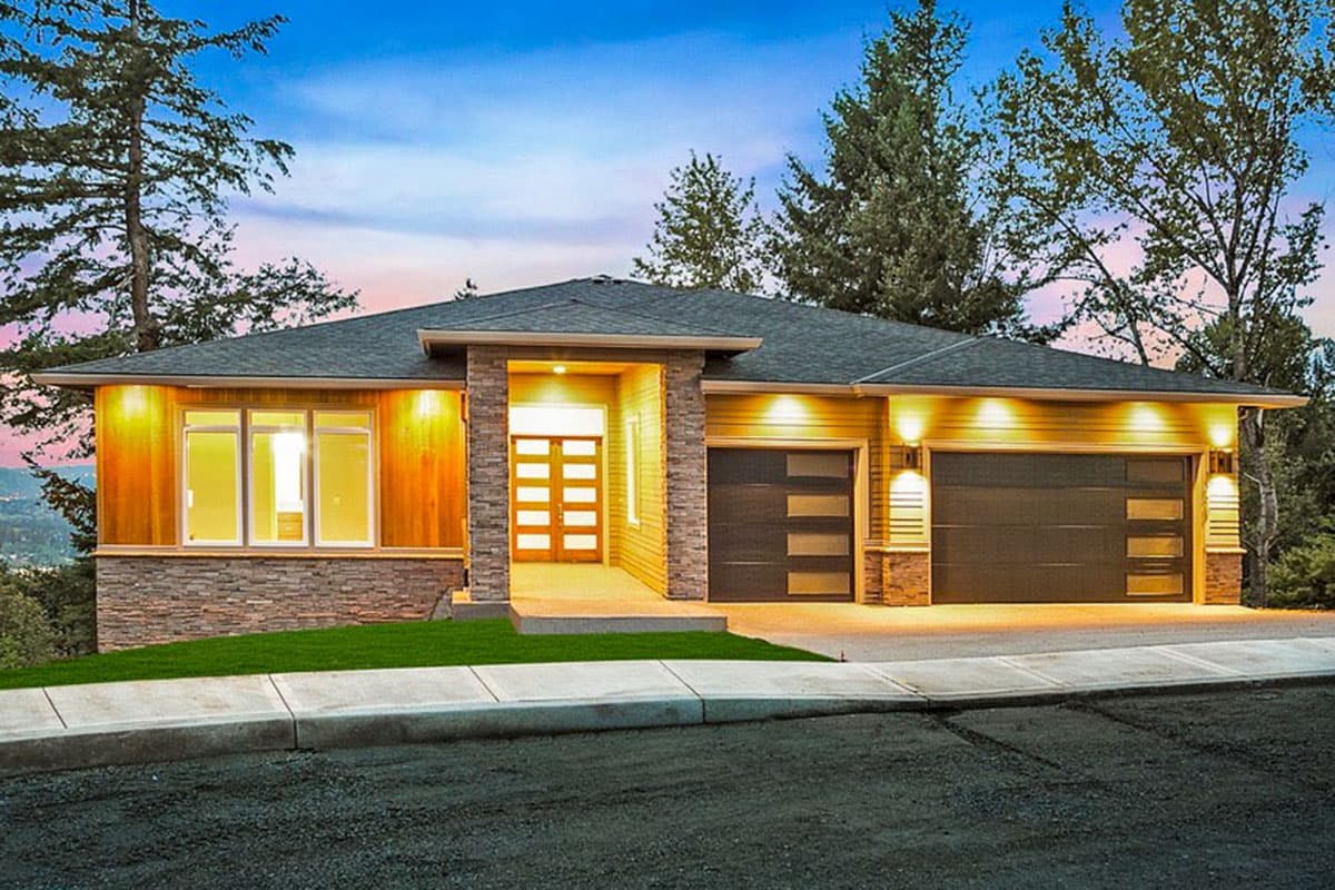 House plan exterior. Modern style, single-story home with a flat roof, stone accents, and two garage bays with glass panels. A covered entry.