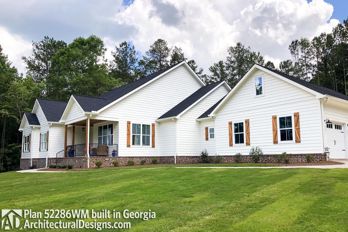 House plan exterior: Ranch style, white siding, covered front porch with wood posts, gables, and wood shutters.