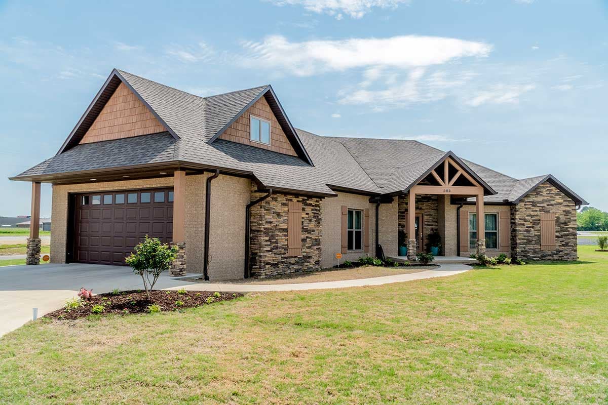 House plan exterior: Ranch style, one story, featuring a covered front porch with wood beams, stone accents, and a side-entry garage.