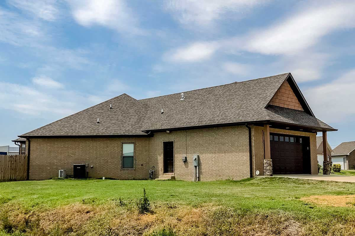 House plan exterior: One-story Ranch with a gable roof, brick exterior, and attached two-car garage.