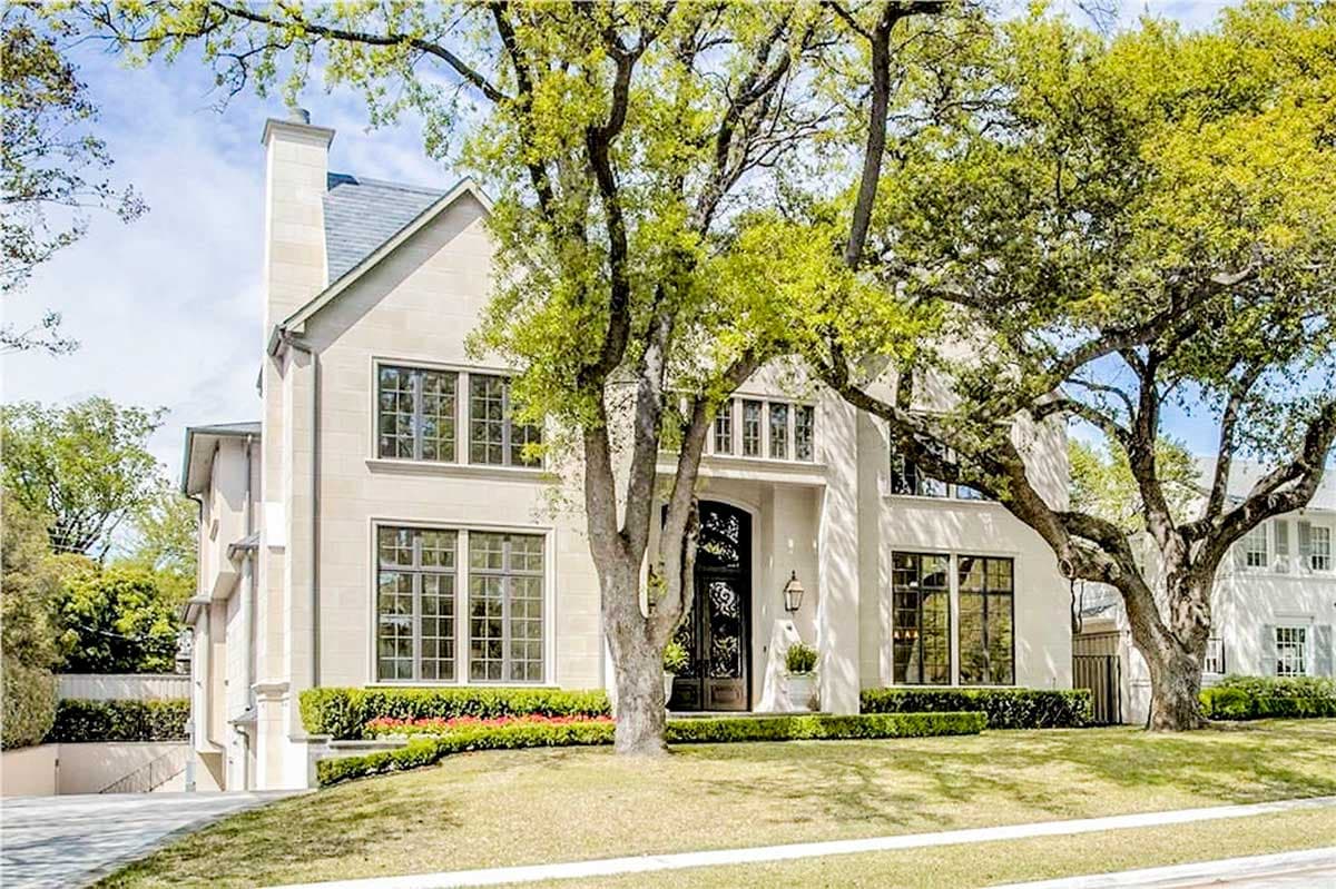 House plan exterior: Limestone facade, multi-story home with gabled roof, large grid windows, and prominent chimney.