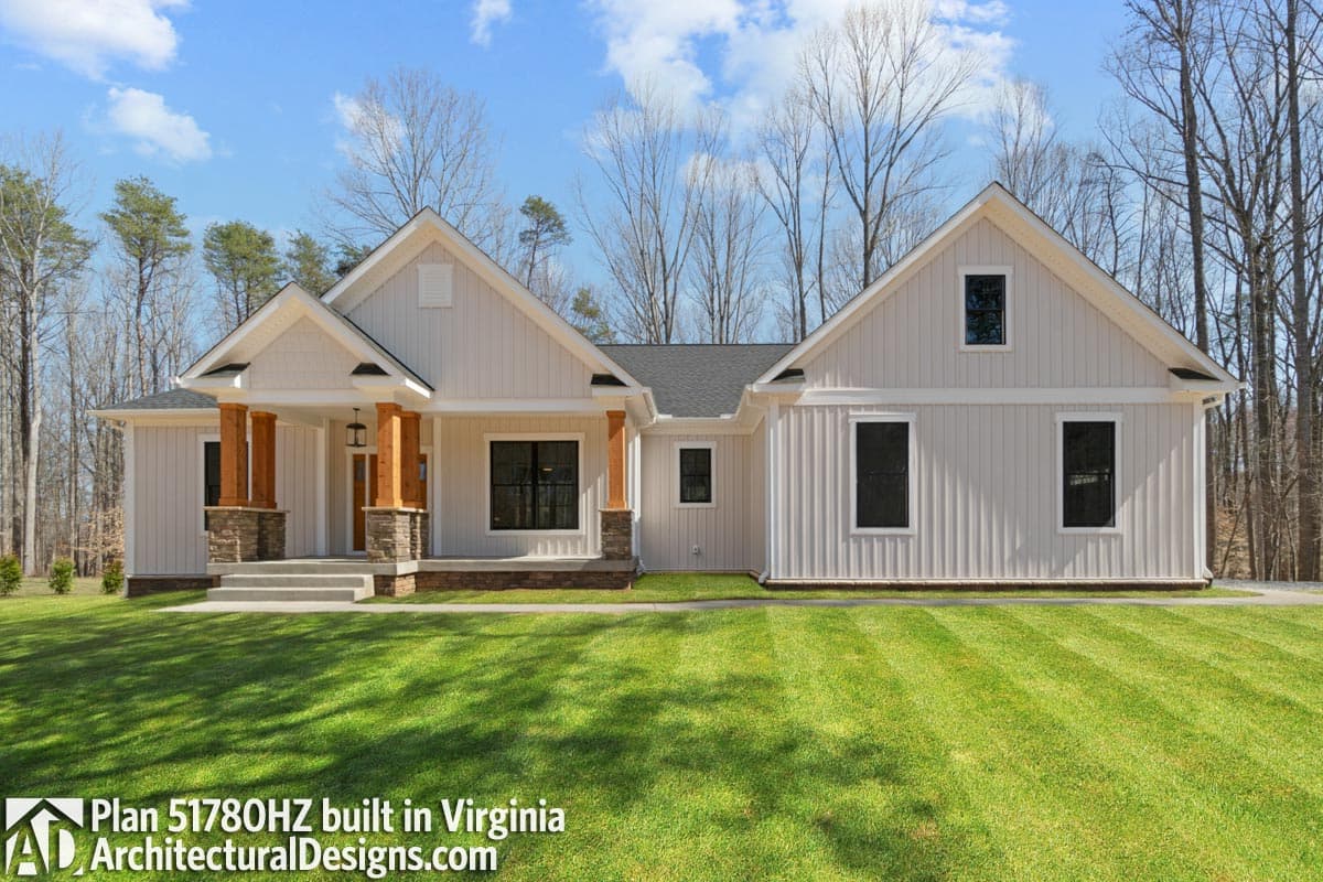 House plan exterior: One-story Modern Farmhouse with a covered front porch, gable rooflines, and vertical siding.
