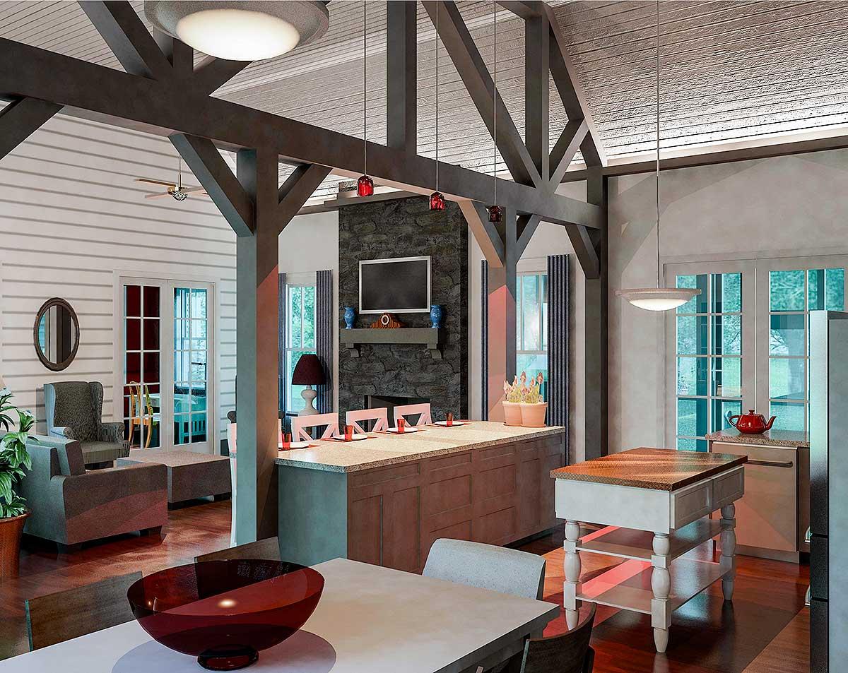 Open concept living area with kitchen island, stone fireplace, vaulted ceiling with exposed beams, and dining area.