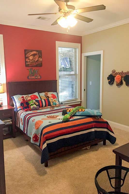 Bedroom with a twin bed, baseball-themed decor, and a ceiling fan.