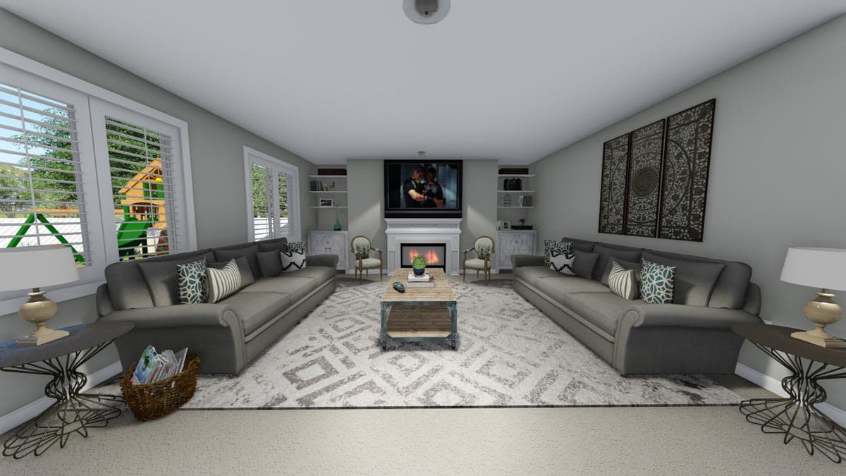 Living room interior with fireplace, TV, two sofas, coffee table, and large windows overlooking a backyard playset.