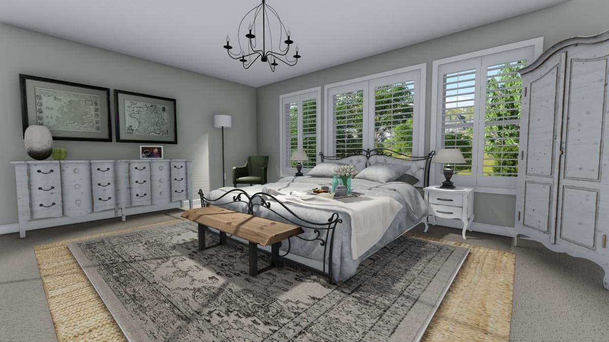 Bedroom interior with a metal-frame bed, white dresser, white armoire, and plantation shutters on windows.