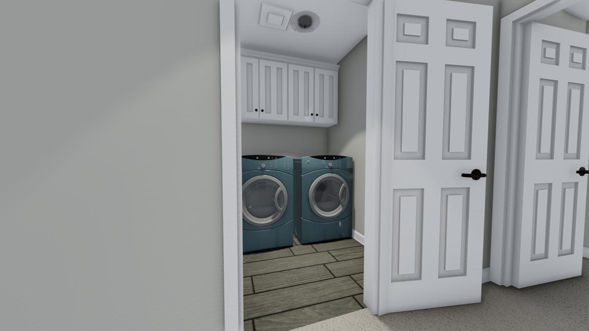 Interior view of a laundry room with two teal washing machines, white cabinets, and wood-look flooring. Two white doors are visible.