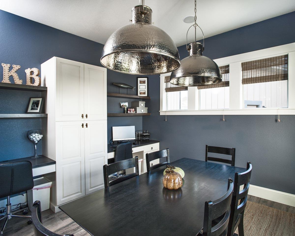 Home office with a dining table, built-in cabinets, and desk area.
