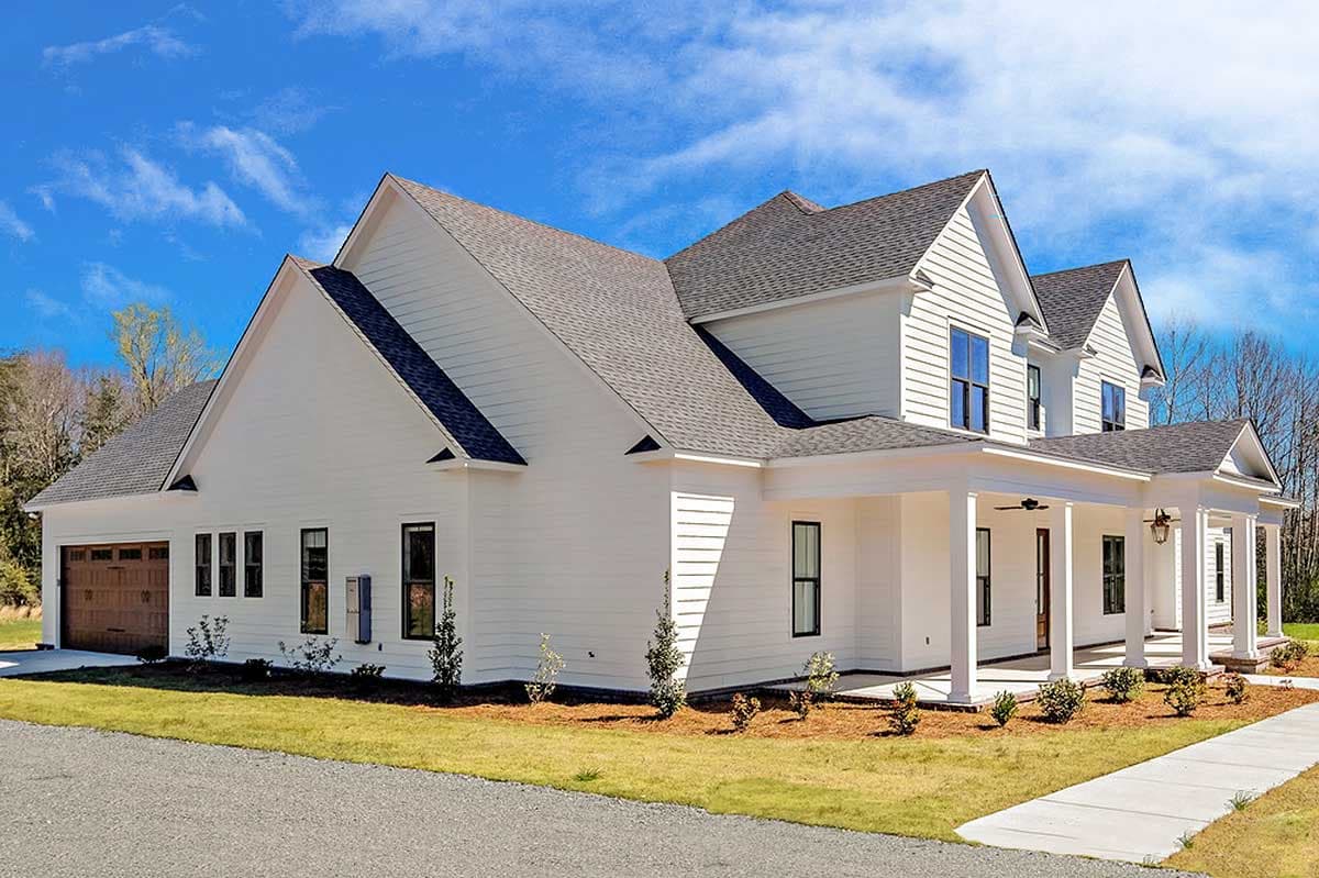 Modern Farmhouse house plan exterior with a wide wrap-around porch, gabled rooflines, and a side-entry garage.