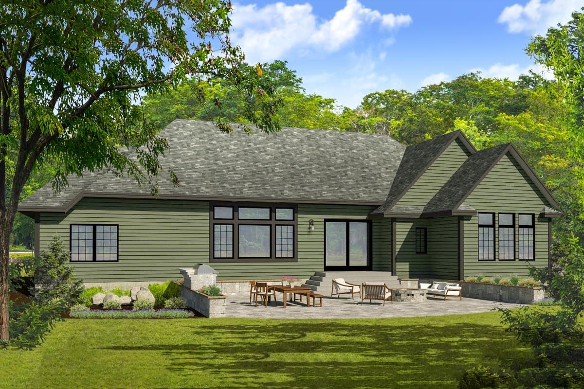 House plan exterior: Ranch style, one story, with gabled dormers, large windows, and a patio with outdoor seating.
