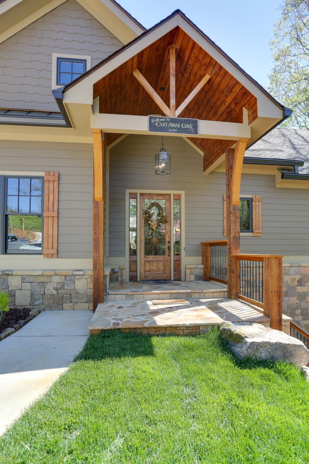 House plan exterior: Craftsman style with a covered porch, stone foundation, wood siding, and decorative gable bracing.