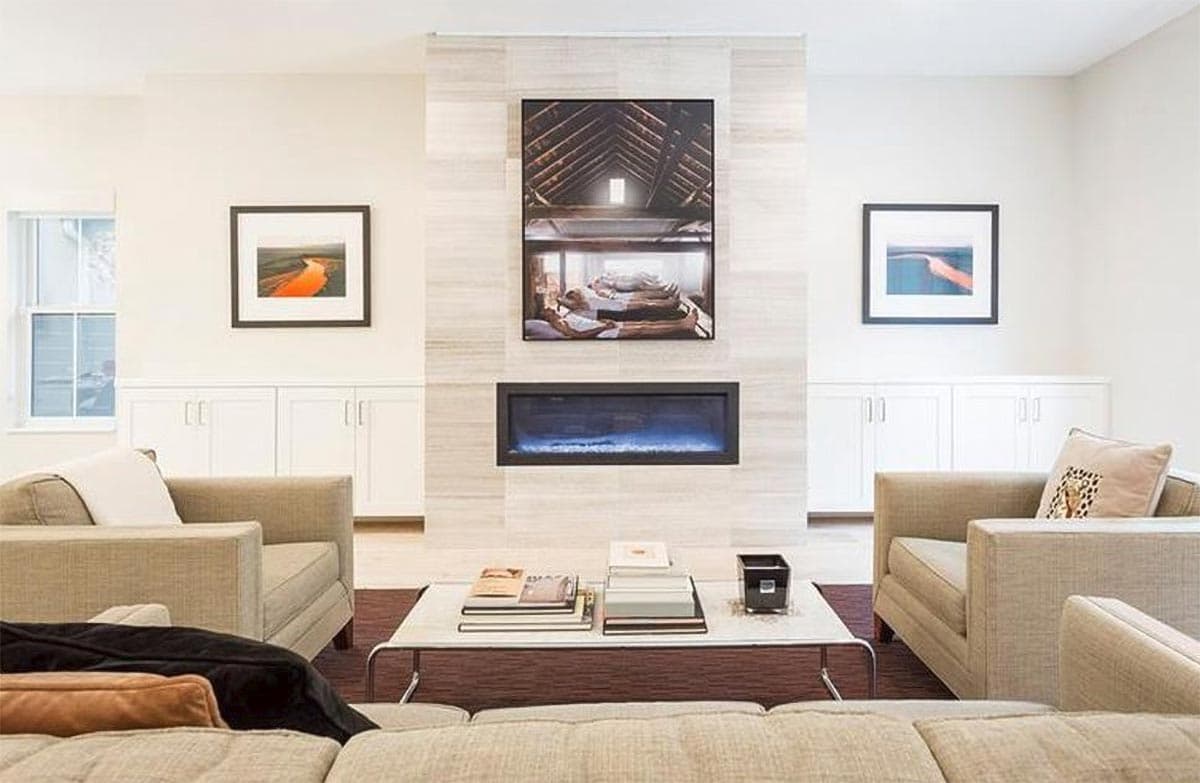 Living room with fireplace, built-in cabinets, and seating. Interior rendering.
