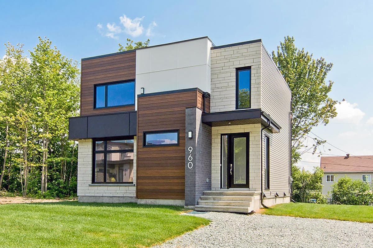 House plan exterior. Two-story modern house with wood siding, brick, and contrasting black trim. Features include flat rooflines and a covered entry.