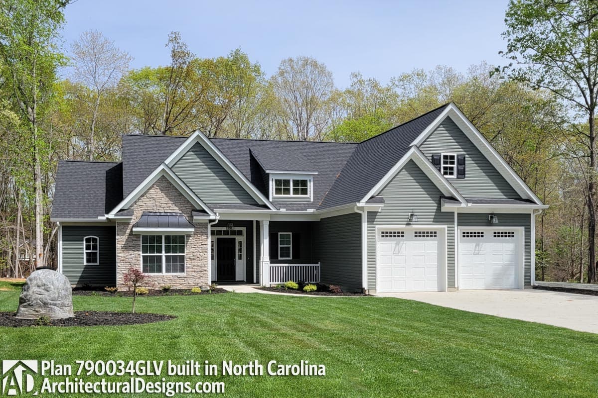 House plan exterior: One-story, Modern Farmhouse style, features stone accents, front porch, and a two-car garage.