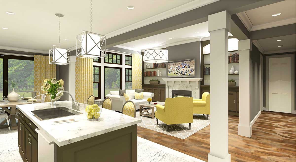Open concept living area with kitchen island, fireplace, built-in bookshelves, and large windows.