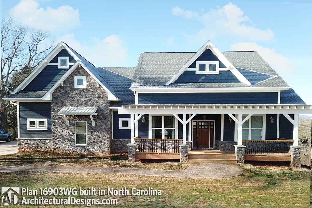 House plan exterior: Modern Farmhouse style, one story, with a covered front porch, stone accents, and prominent gables.