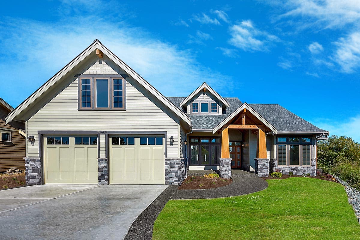 Craftsman style house plan exterior with a two-car garage, prominent gables, dormers, and stone accents.