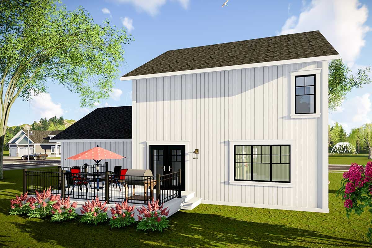 House plan exterior featuring vertical siding, a dark asphalt shingle roof, double doors, and a raised deck with outdoor furniture.