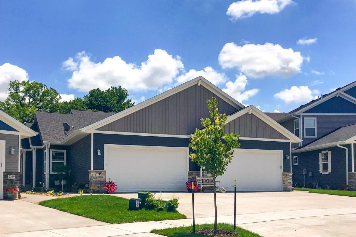 House plan exterior. Two-story, Modern Farmhouse style with gabled roof, two-car garage, and stone accents.