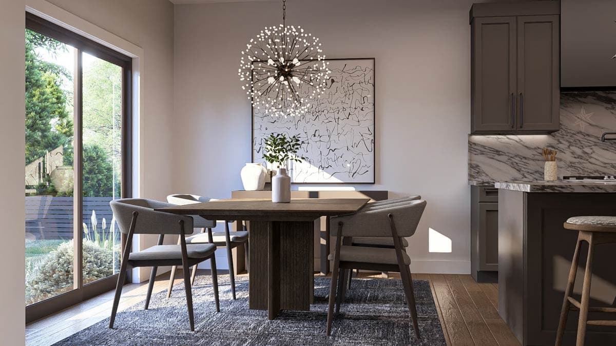Dining area with table and chairs near large sliding glass doors and an adjacent kitchen with a marble backsplash and island.