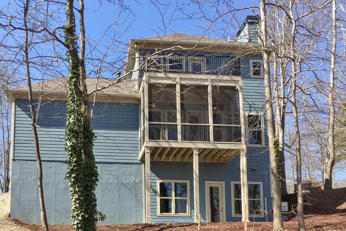 House plan exterior, 3 stories, light blue siding, screened porch, deck, and balconies.